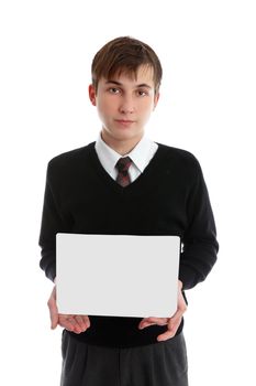 A teen boy holds a sign, book, brochure or other object in front of him.  White background.