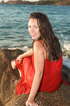 retty young woman relaxing on the beach with a free feeling