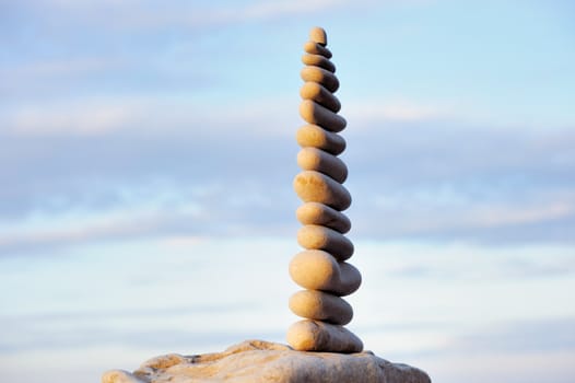 White pebbles composed one on another, against the sky