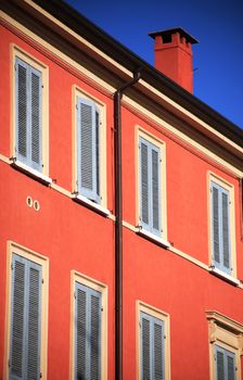 Red chimney on colored building