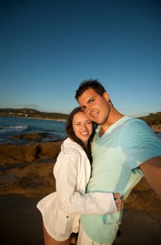 Love couple enjoying the sunset on the beach