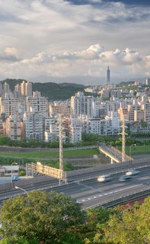 It is a cityscape photo of apartments and highway.