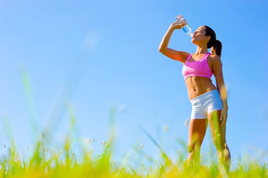 Athletic woman working out in a meadow, from a complete series of photos.