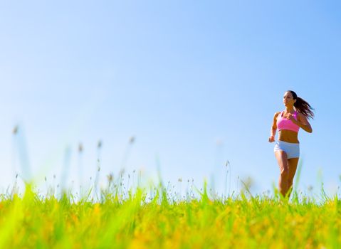 Athletic woman working out in a meadow, from a complete series of photos.