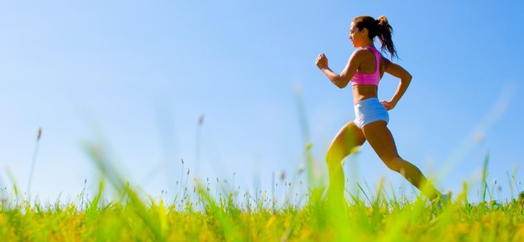 Athletic woman working out in a meadow, from a complete series of photos.