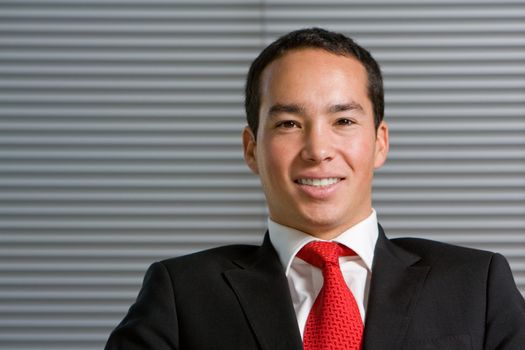 Happy asian business man in formal suit with a large smile