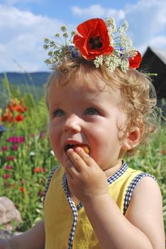 girl eating strawberries , in floral wreath