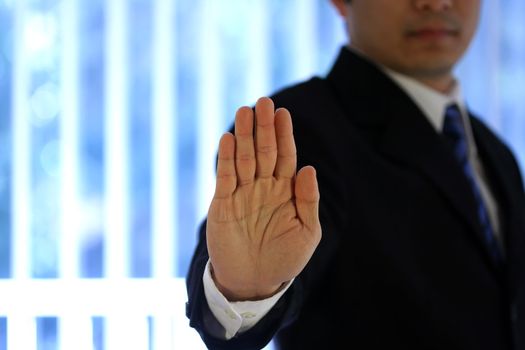 Businessman with hand raised