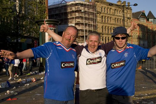 three Rangers fan supporters partying before the uefa cup match