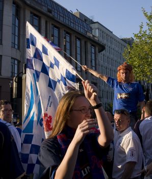 Rangers fan waving a flag above the crowd