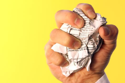 Businessman crumpling paper, showing anger/frustration