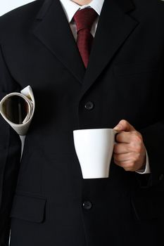 Businessman with newspaper and a cup of coffee