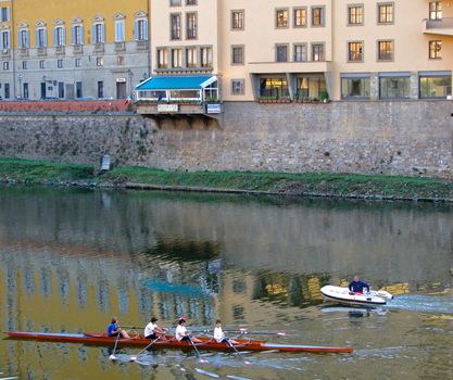 A rowing team practices on the Arno River in Florence, Italy.
