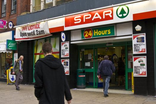 People entering the a spar shop