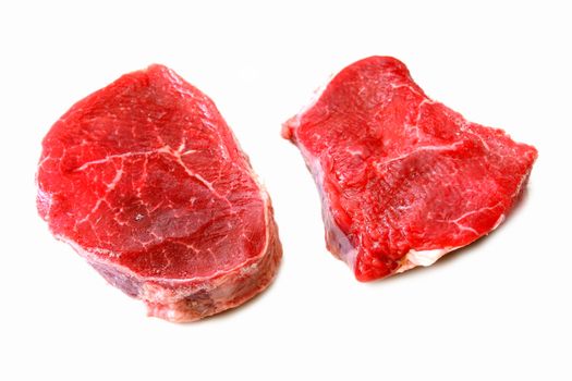 Two raw steaks isolated on a white background
