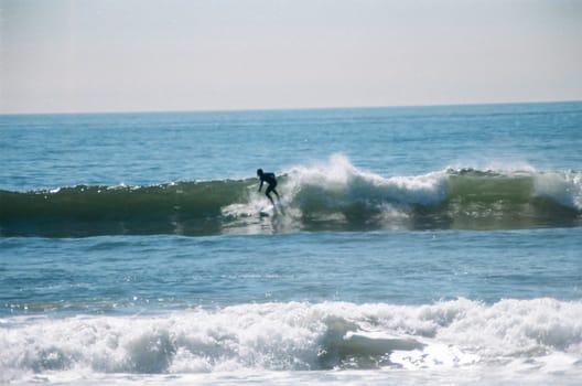 A surfer riding a wave in the pacific ocean