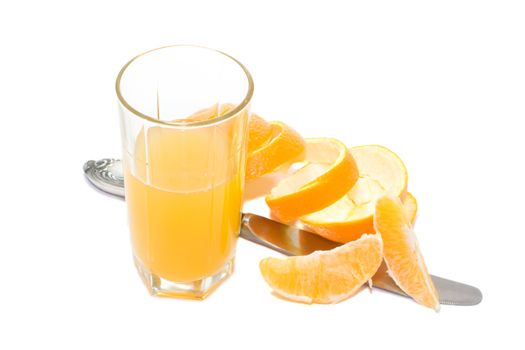glass with orange juice and knife and orange segments and orange skin, isolated on white