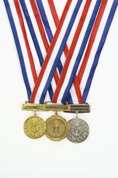 three different medals from various scholastic awards
