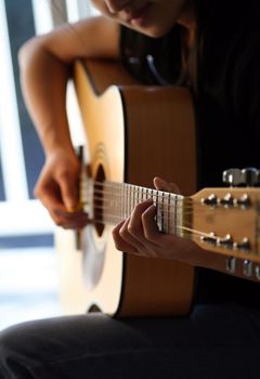 A woman playing guitar