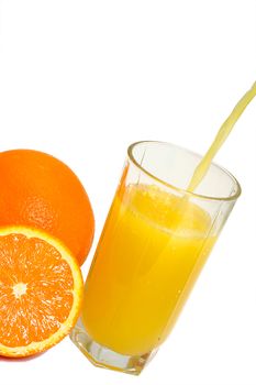 oranges and glass filling with juice, isolated on white