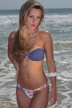 A blonde, 20-30 year old female model on the beach, in Florian�polis - Brazil. This is part of a series. Have a look at the other photos of this model in various outfits and poses.