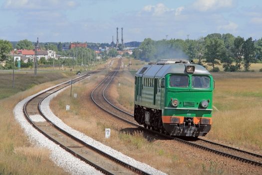 Lonely diesel locomotive passing through countryside
