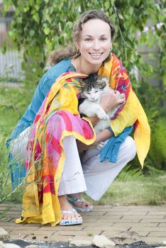 Happy woman holding fluffy cat in her hands