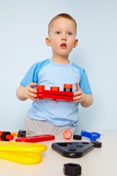 A child plays with plastic toy parts