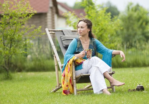 Young woman relaxing on a deck chair