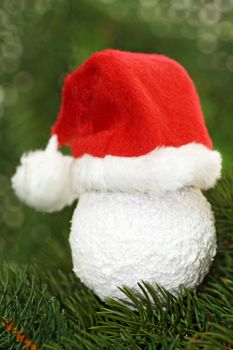 Christmas tree ball with santa claus cap  on green background