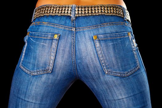 Sexy female ass dressed in jeans on black background