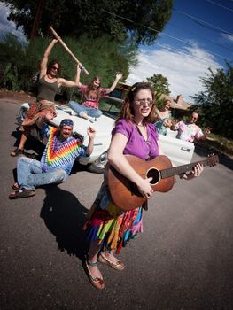 Group of hippies with female guitar player