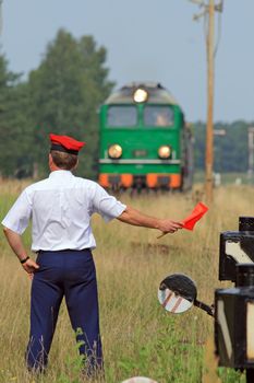 Railway traffic controller giving a signals to the train crew
