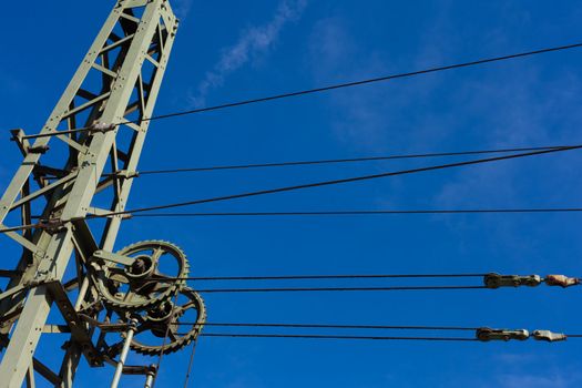 Overhead contact wires of electrified railway tracks kept under tension.