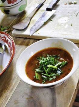 Traditional Thai cuisine of Tom Yum soup made outdoors at a cooking school