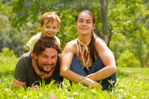 Photo of a family enjoying a summer day on a green meadow