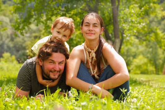 Photo of a family enjoying a summer day on a green meadow