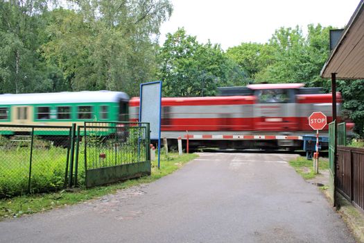 Train passing the road crossing at high speed
