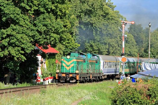 Passenger train with two engines starting from the station
