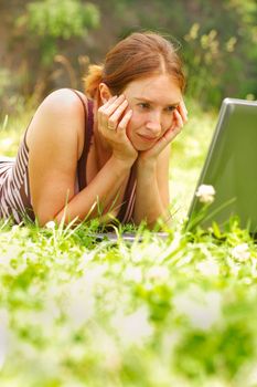 Young woman using her laptop outdoors.