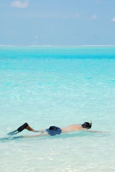 young man snorkeling in a tropical island