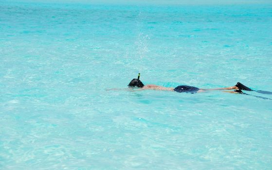 young man throwing water during snorkeling activity