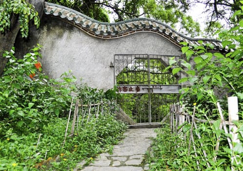 A chinese style gate in a park outside a buddhist temple