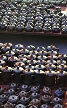 Various chinese teapots and pots for sale in a market