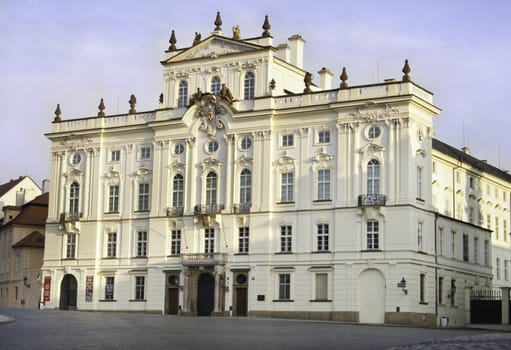 the white prague palace outside of the castle front gate