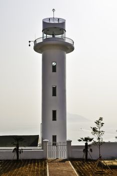 A round modern lighthouse on the coast in southern Korea