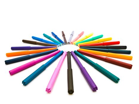 Set of the multicolored felt pens in round shape against the white background 