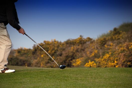 a senior man ready to hit golf ball