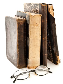 old books and glasses near it against white background 