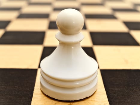 photo of the single white pawn at chessboard